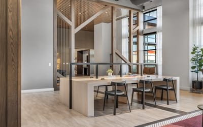 Modern common area with dining table and chairs.