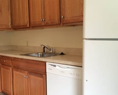 Facility kitchen area with cabinets and appliances.