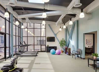 Bright, spacious fitness area with exercise equipment