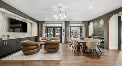 Modern common area with comfortable seating and dining table.