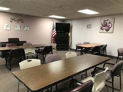 Interior view of a common room with tables and chairs