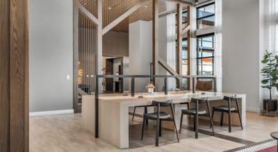 Modern common area with a dining table and seating.