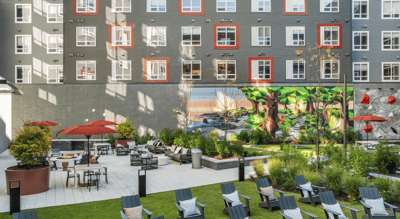 Outdoor patio area with seating and greenery.