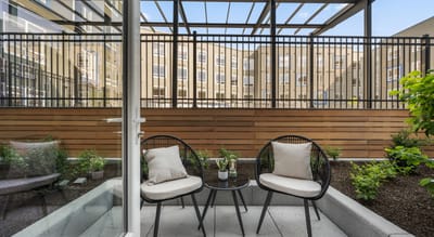 Outdoor seating area with plants and architectural features.