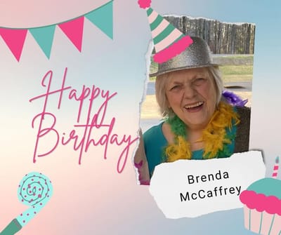 Birthday celebration with resident wearing festive hat.
