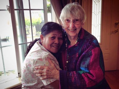 Two residents enjoying a joyful moment together indoors.