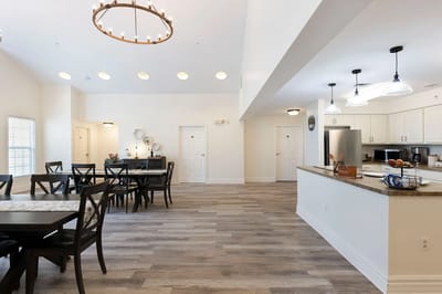 Bright dining area with tables and a kitchen