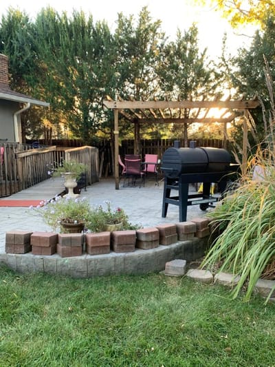 Outdoor patio area with seating and a grill