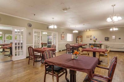 Bright dining room with tables set for residents
