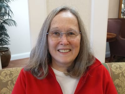 Resident smiling in a cozy interior setting