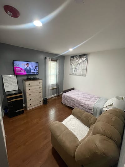 Resident room with a bed and television.