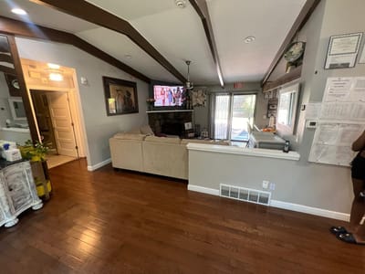Interior common area with seating and a TV.