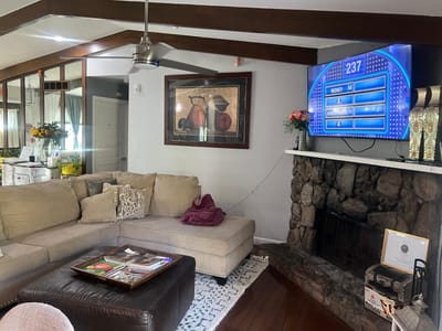 Cozy common area with a large sofa and TV.