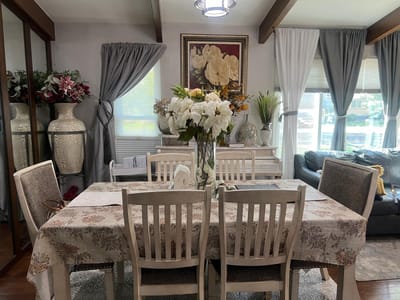 Well-decorated common area with a dining table