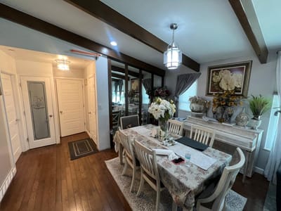 Dining area with a large table and floral decor.