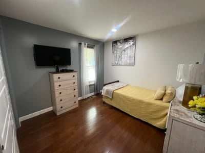 Private resident room with a bed and dresser