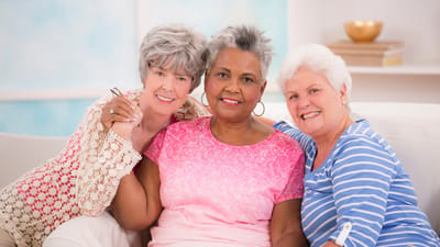 Three smiling women enjoying each other's company