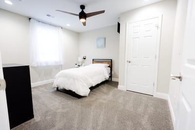 Cozy private resident room with bed and furnishings