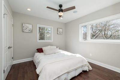 Bright, well-decorated private room with a bed and artwork