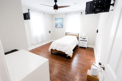Bright, modern private resident room with a bed and furniture