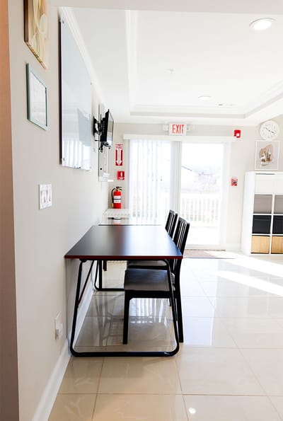 Bright interior view of a common area with tables and chairs