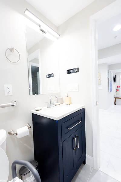 Brightly lit bathroom with modern fixtures and decor