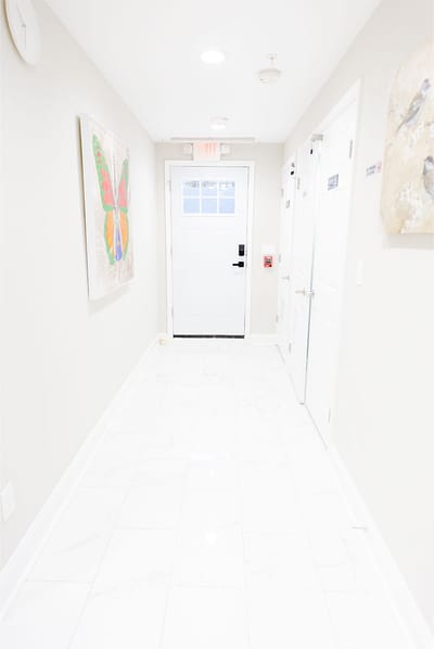 Bright hallway with white walls and tiled floor