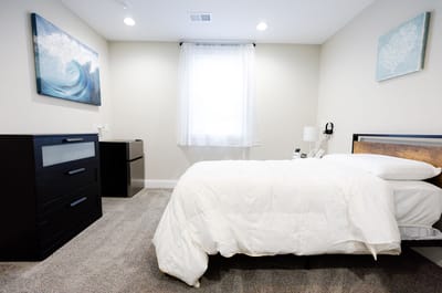 Cozy resident room with a bed and dresser