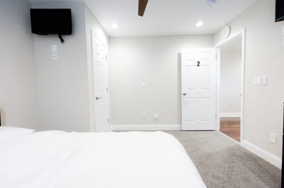 Cozy interior of a resident room with a bed and door