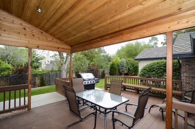 Outdoor patio area with seating and grill