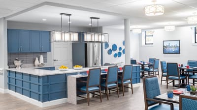 Modern dining area with blue decor and bright lighting