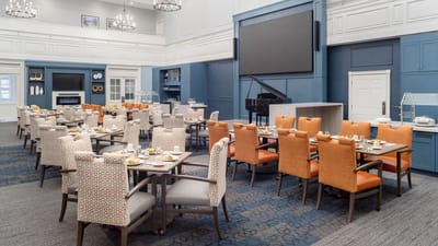 Bright dining room with tables set for meals