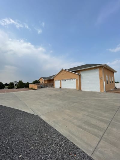 Exterior view of a cozy adult care home with parking area