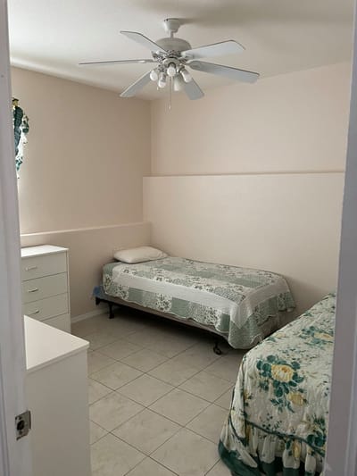 A cozy resident room with two beds and bright decor