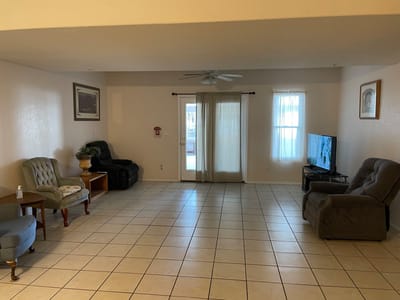 Spacious common area with seating and a television