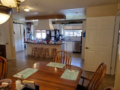 Bright kitchen area with dining table and appliances