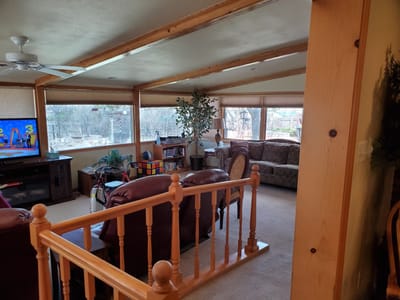 Bright interior common area with seating and television