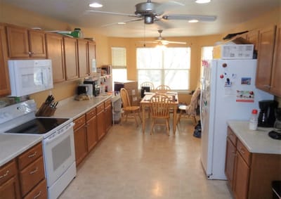 Bright kitchen space with wooden cabinets and dining area