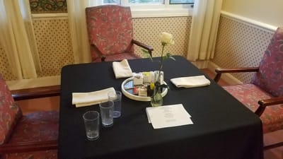 A dining table set for a meal with floral decor