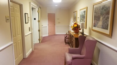Interior hallway with seating and floral decor