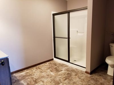 Interior view of a bathroom with shower and toilet