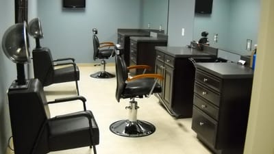 Interior view of a hair salon with empty chairs
