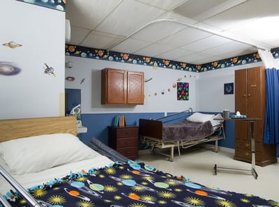 A shared resident room with decorative space theme