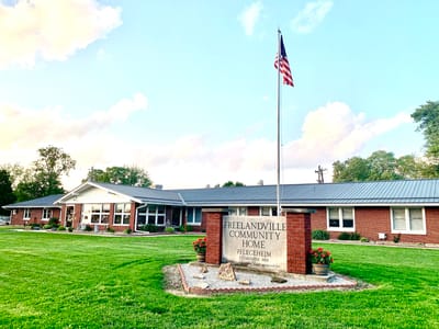 Exterior view of Freelandville Community Home with flag