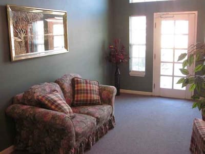 Cozy common area with floral couch and natural light