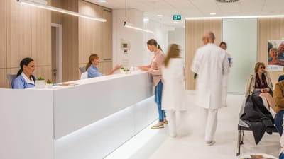 Reception area with staff and residents interacting.