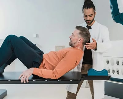 Therapist assisting a man in a rehabilitation session.