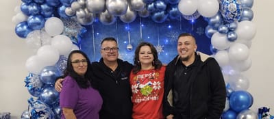 Staff and residents posing together in festive celebration