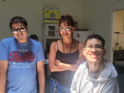 Three staff members smiling in an activity room