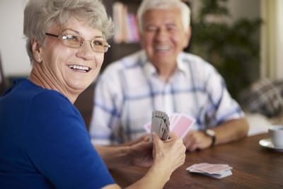 Residents enjoying a card game in an activity room